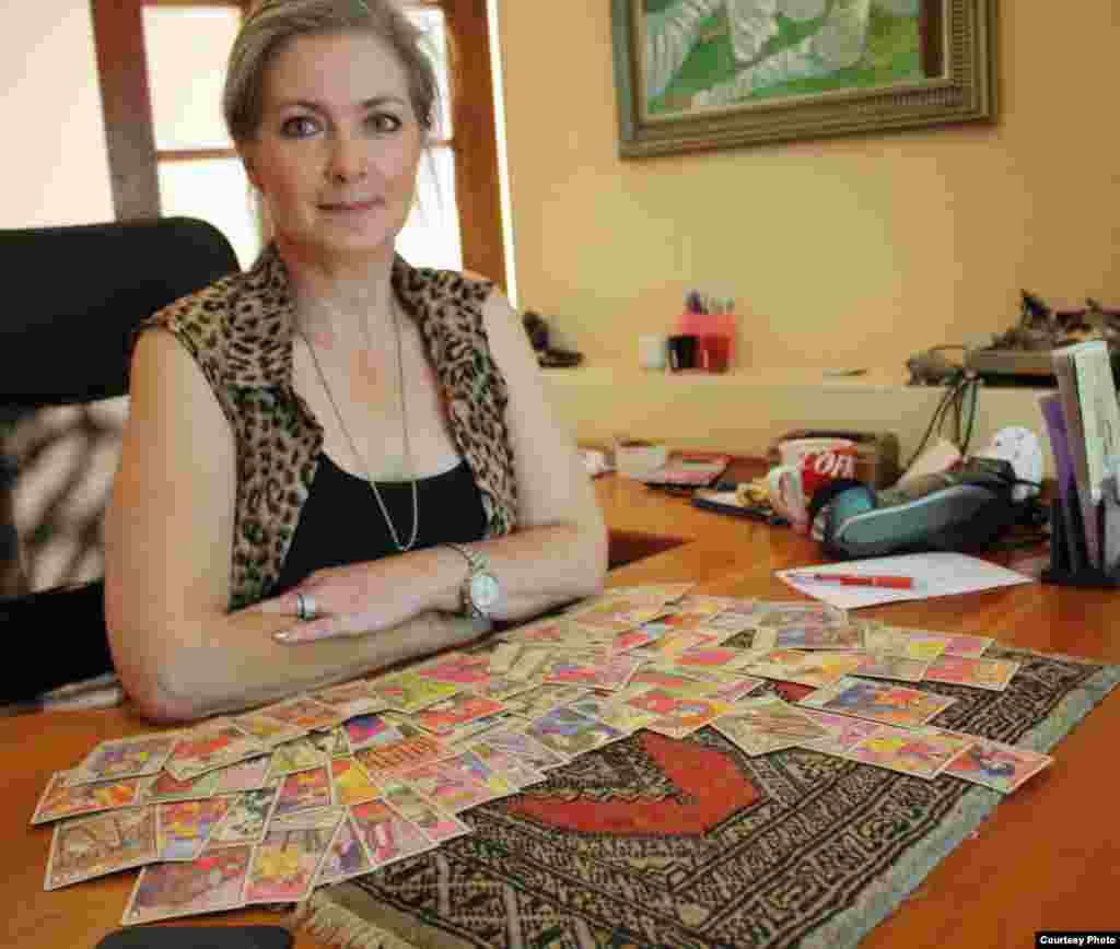 Ursula Wania reads the future in a deck of tarot cards for clients in the quiet of a study in her home in Sharonlea, a suburb of Johannesburg, South Africa. (Photo by Darren Taylor)