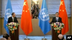 Chinese Foreign Minister Wang Yi, right, speaks during a joint press conference with U.N. Secretary-General Ban Ki-moon at the Diaoyutai State Guesthouse in Beijing on July 7, 2016.