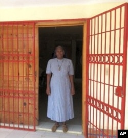 Sister Nellie stands in front of the hospital