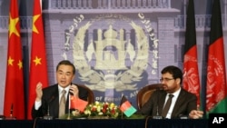 Chinese Foreign Minister Wang Yi, left, speaks during a press conference with his Afghan counterpart Zarar Ahmad Osmani at the foreign ministry in Kabul, Afghanistan, Feb. 22, 2014.
