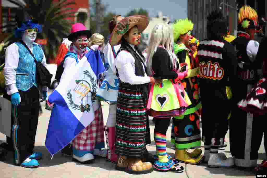 Clowns line up during the 22nd Latin American clown convention at Revolucion monument in Mexico City, Mexico, Oct 18, 2017.