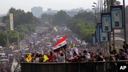 Supporters of Egypt's ousted president Mohamed Morsi stand on a bridge as they march during his trial in Cairo, Egypt, Nov. 4 2013.