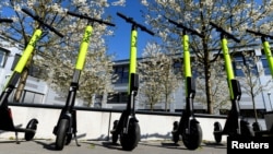 FILE - E-scooters are lined up during a presentation at the DESY campus in Hamburg, Germany, April 16, 2019. 