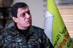 FILE - Mazloum Kobani, commander-in-chief of the Syrian Democratic Forces (SDF), speaks during an interview in the countryside outside the northwestern Syrian city of Hasakah, in a province of the same name, Jan. 24, 2019.