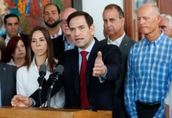 Senator Marco Rubio, center, R-Fla., speaks to members of the media after he, Sen. Rick Scott, right, R-Fla., and Rep. Mario Diaz-Balart, second from right, R-Fla., met with Venezuelan, Colombian and Cuban community leaders, June 19, 2019
