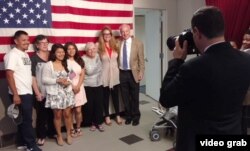 New U.S. citizen Reyna Pacheco, 21, center, came to the U.S. from Mexico when she was 4. Just two days prior, she celebrated another milestone — a college degree from Columbia University.