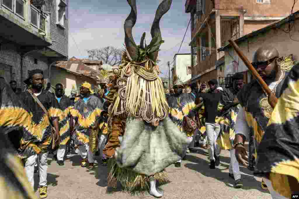 Members of the &#39;Ekum Baba&#39; light up the streets of Banjul ahead of the annual hunting festival in Banjul, Gambia, Jan. 1, 2025.&nbsp;Rooted in tradition, this vibrant celebration marks the New Year with music, dancing, and a fierce yet friendly competition between hunting societies for the title of the best display of animal heads, masks and costumes.