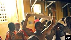 Supporters of Guinean presidential candidate Alpha Conde celebrate at his headquarters after it was announced by the National Independent Electoral Commission that the preliminary results showed he had won Guinea's tense presidential election, 15 Nov 2010