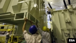 FILE - workers operate at a transformer manufacturing workshop of Dong Anh Electrical Equipment Corporation-Joint Stock Company in Hanoi, Vietnam.