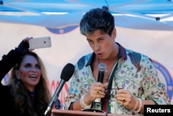 FILE - Milo Yiannopoulos speaks to a group protesting against CUNY’s decision to allow Linda Sarsour, a liberal Palestinian-American political activist, to speak at commencement in New York, May 25, 2017.