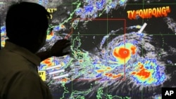Forecaster Meno Mendoza shows the path of Super Typhoon Mangkhut, locally named "Typhoon Ompong," as it approaches the Philippines at the Philippine Atmospheric, Geophysical and Astronomical Services Administration in Manila, Sept. 12, 2018.