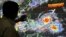 Forecaster Meno Mendoza shows the path of Super Typhoon Mangkhut, locally named "Typhoon Ompong," as it approaches the Philippines at the Philippine Atmospheric, Geophysical and Astronomical Services Administration in Manila, Sept. 12, 2018.