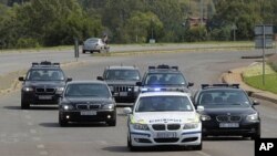 A security convoy leaves 1 Military Hospital, shortly before it was announced that former President Nelson Mandela had been discharged from an undisclosed hospital, in Pretoria, February 26, 2012.