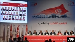 Members of the Independent Higher Authority for Elections (ISIE) announce the official results of the presidential election during a press conference in Tunisia's capital, Tunis, Sept. 17, 2019. 