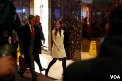 U.S. Sen. Joe Manchin, a Democrat from West Virginia, is escorted past security by a Trump aide, at Trump Tower in New York, Dec. 12, 2016. (R. Taylor/VOA)