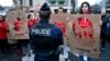 Members of Reporters Without Borders hold stencils representing portraits of detained Turkish journalists, during a demonstration in front of the Turkish embassy, in Paris, Jan. 5, 2018.