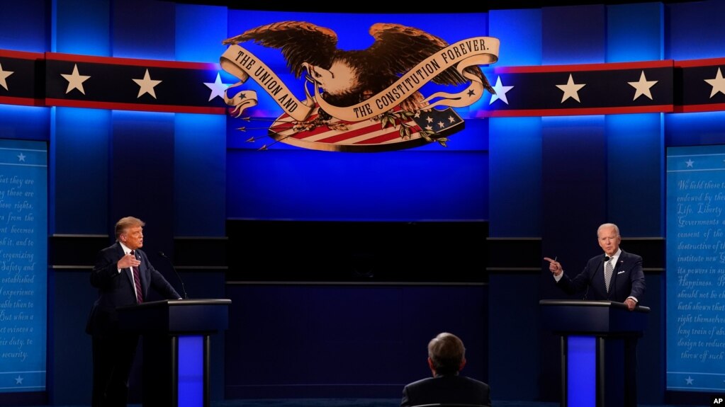 President Donald Trump, left, and Democratic presidential candidate former Vice President Joe Biden, right, with moderator Chris Wallace, center, of Fox News during the first presidential debate Tuesday, Sept. 29, 2020, at Case Western University…