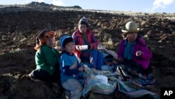 The Pacco family eats dinner after harvesting potatoes in Paru Paru, in the Cusco region of Peru, May 26, 2016. The International Potato Center, based in Lima, collaborates with peasants to reintroduced native potatoes that are more resistant to climate change.