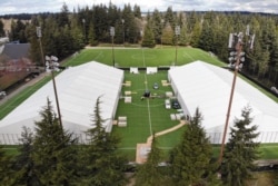Two massive temporary buildings meant for use as a field hospital for coronavirus patients stand together on a soccer field in the Seattle suburb of Shoreline, Washington, March 24, 2020.