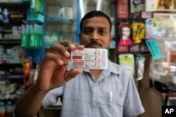 FILE - A chemist displays hydroxychloroquine tablets in Mumbai, India, May 19, 2020.