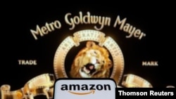 FILE PHOTO: Smartphone with Amazon logo is seen in front of displayed MGM logo in this illustration taken