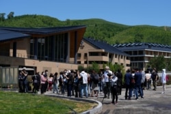 FILE - Journalists tour the Olympics Village for Beijing 2022 Olympic and Paralympic Winter Games and Paralympic Winter Games, during a media tour in Zhangjiakou in northwestern China's Hebei province, July 14, 2021.