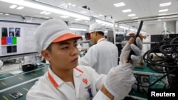 FILE - A manufacturer works at an assembly line of Vingroup's Vsmart phone in Hai Phong, Vietnam, Dec. 4, 2018.