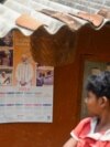 FILE - A boy looks at a calendar with a portrait of India's Prime Minister Narendra Modi in Tatem village some 43 Km (27 miles) from Dantewada town in Chhattisgarh state on April 16, 2024.