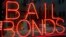 FILE - In this July 7, 2015, file photo, a sign advertising a bail bonds business is displayed near Brooklyn's jail and courthouse complex in New York. 