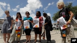 Clergy with Women of Faith pray outside of a U.S. Customs and Border Patrol processing center, Wednesday, June 27, 2018, in McAllen, Texas. The group traveled to McAllen to pray for detained immigrants. (AP Photo/Eric Gay)