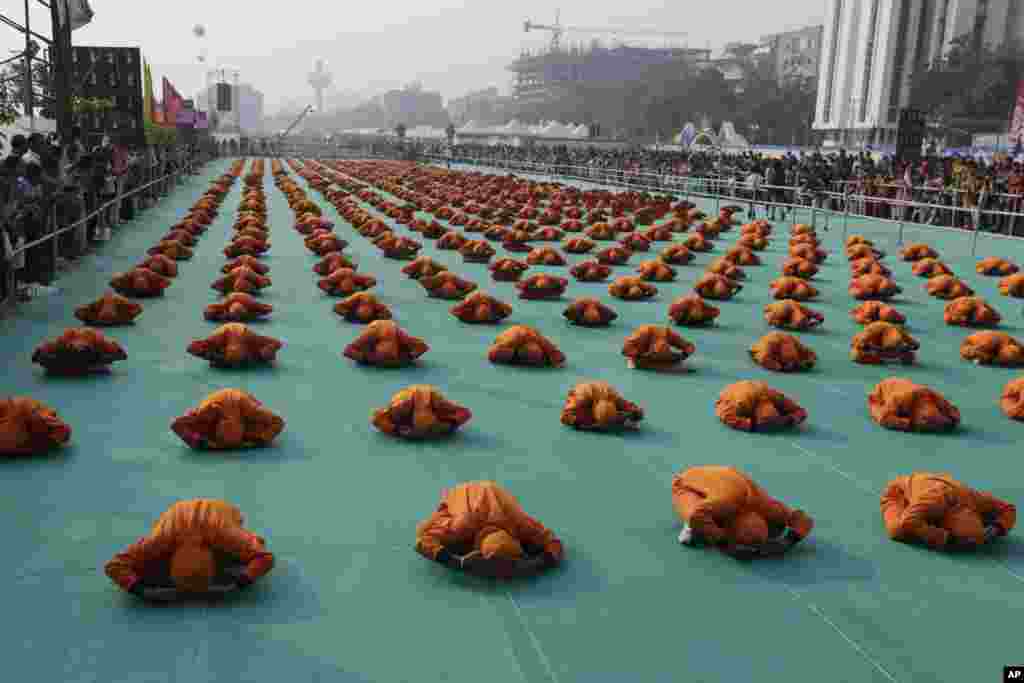 Indian school children perform yoga during the inauguration of an international kite festival in Ahmadabad.