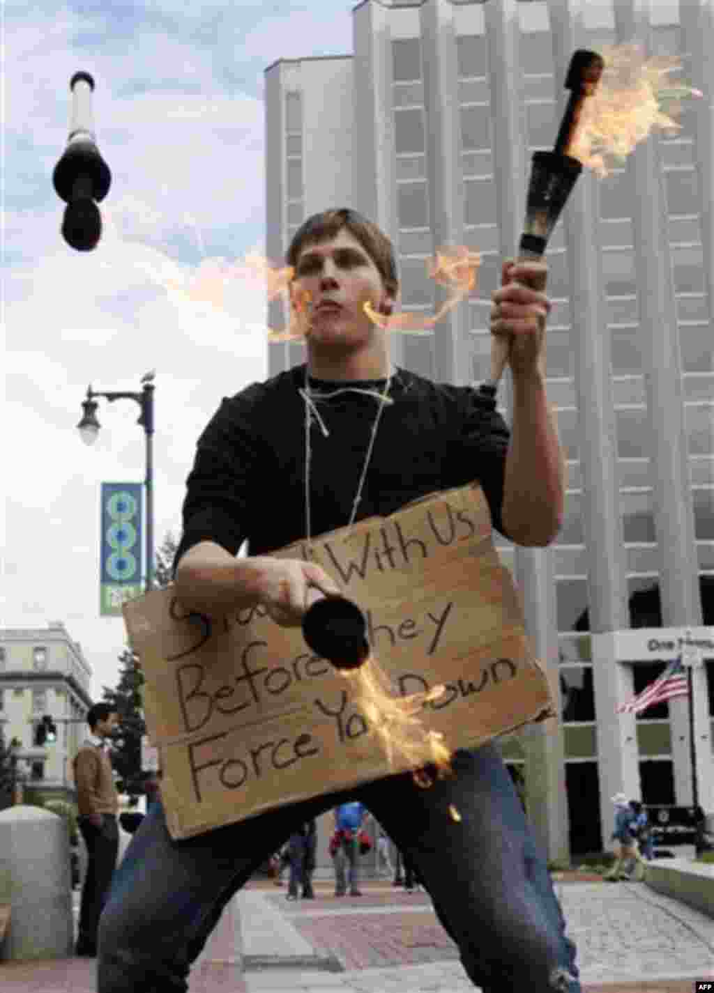 David Bruenjes, of Portland, Maine, juggles during a protest in Portland, Maine, on Monday, Oct. 3, 2011. A group calling itself "Occupy Maine" that joined in solidarity with Wall Street protesters in New York is wrapping up its 3-day demonstration agains