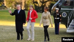 FILE - U.S. President Donald Trump, First Lady Melania Trump and Barron Trump walk from Marine One as they return to the White House in Washington, March 10, 2019. 