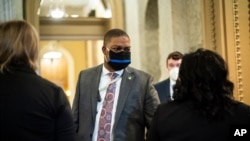 Capitol Hill Police Officer Eugene Goodman speaks with others after the fourth day of the Senate Impeachment trials for former President Donald Trump on Capitol Hill in Washington, Feb 12, 2021.