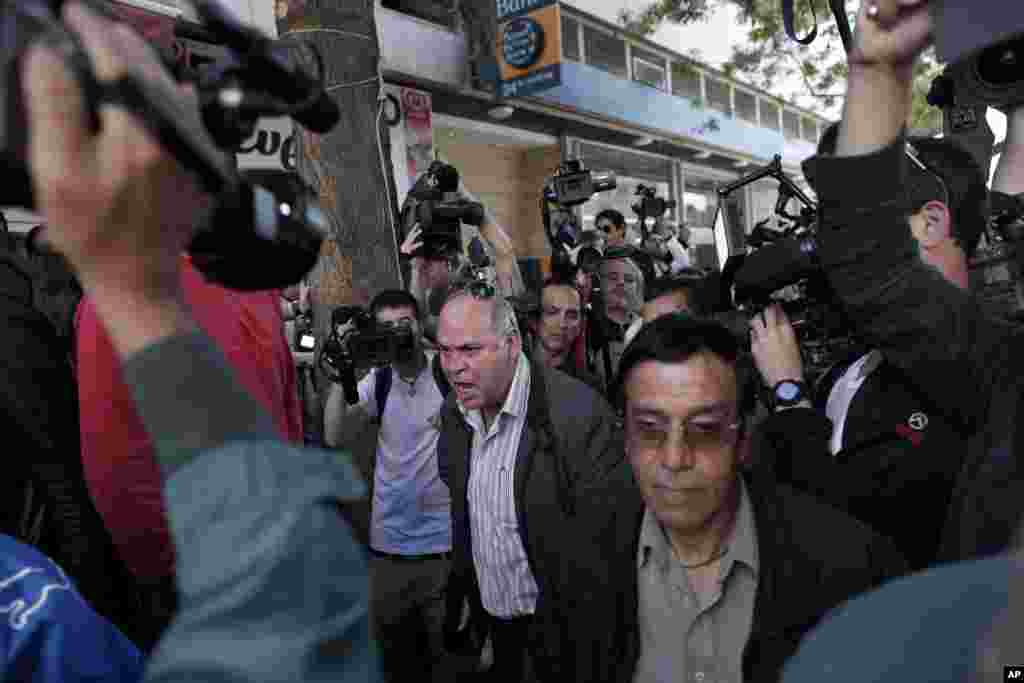 A man reacts outside a branch of the Bank of Cyprus in Nicosia, March 28, 2013.