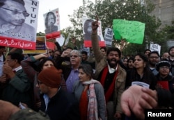 FILE - Human rights activists chant slogans during a protest to condemn the disappearances of social activists in Karachi, Pakistan, Jan. 19, 2017.