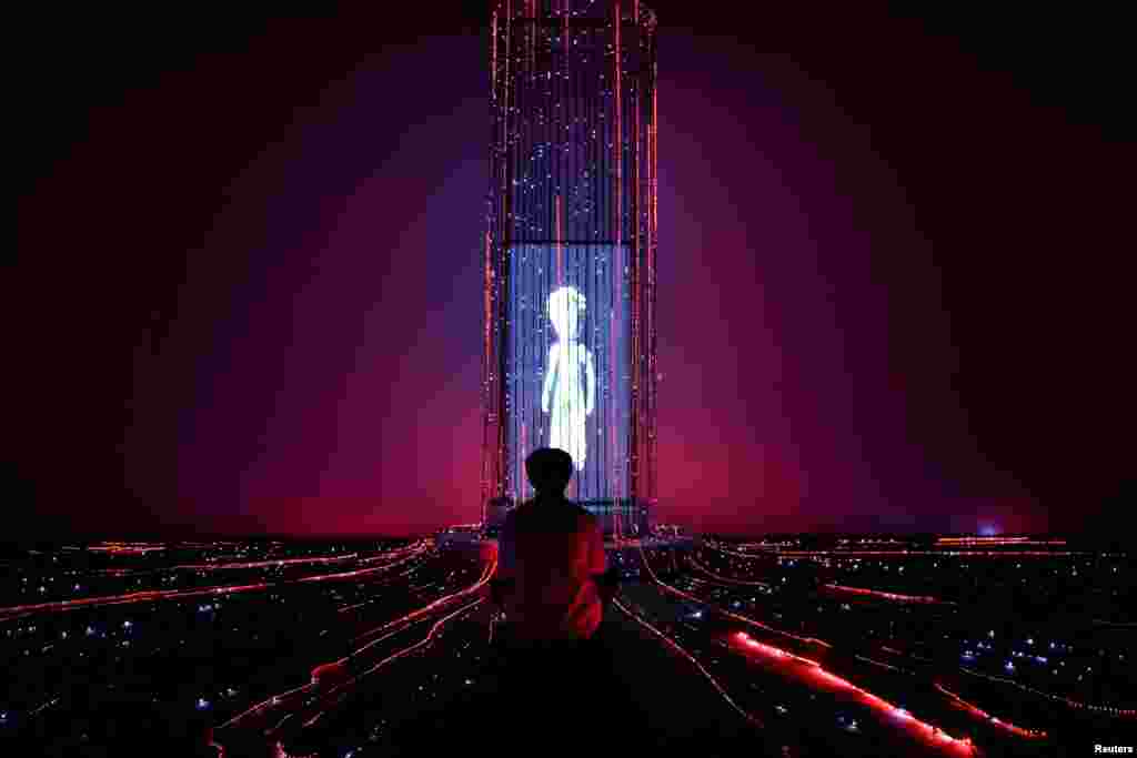 A man sits attends &quot;The Little Prince Universe &mdash; An Immersive Journey,&quot; a show of mixed digital interactive experiences and installations, based on Antoine de Saint-Exupery&#39;s novella &quot;The Little Prince,&quot; in Bangkok, Thailand.