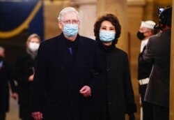 Sen. Mitch McConnell, R-Ky., and former Secretary of Transportation Elaine Chao arrive in the Crypt of the U.S. Capitol for President-elect Joe Biden's inauguration ceremony, in Washington, Jan. 20, 2021.