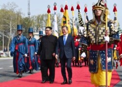 FILE - North Korean leader Kim Jong Un, left, and South Korean President Moon Jae-in walk together at the border village of Panmunjom in the Demilitarized Zone, April 27, 2018.
