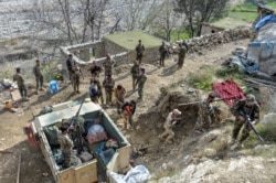 FILE - Afghan security forces take part in an ongoing operation against Islamic State (IS) militants in the Achin district of Nangarhar province, Nov. 25, 2019.