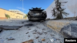 FILE - A burned car is seen after clashes in Tripoli, Libya August 28, 2022.