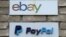FILE - Signs are posted outside the offices of online marketplace eBay and its electronic payments division PayPal in Toronto, Canada.