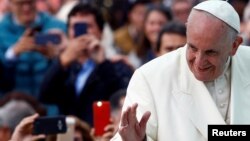 FILE - Pope Francis waves to the crowd as he arrives for a holy mass at Simon Bolivar park in Bogota, Colombia, Sept. 7, 2017. 