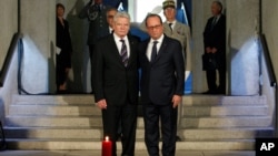 France's President Francois Hollande, right, stands with German President Joachim Gauck, left, as they pay respect in the crypt of the the National Monument of Hartmannswillerkop, in Wattwiller, eastern France, Aug. 3, 2014, to mark the 100th anniversary 
