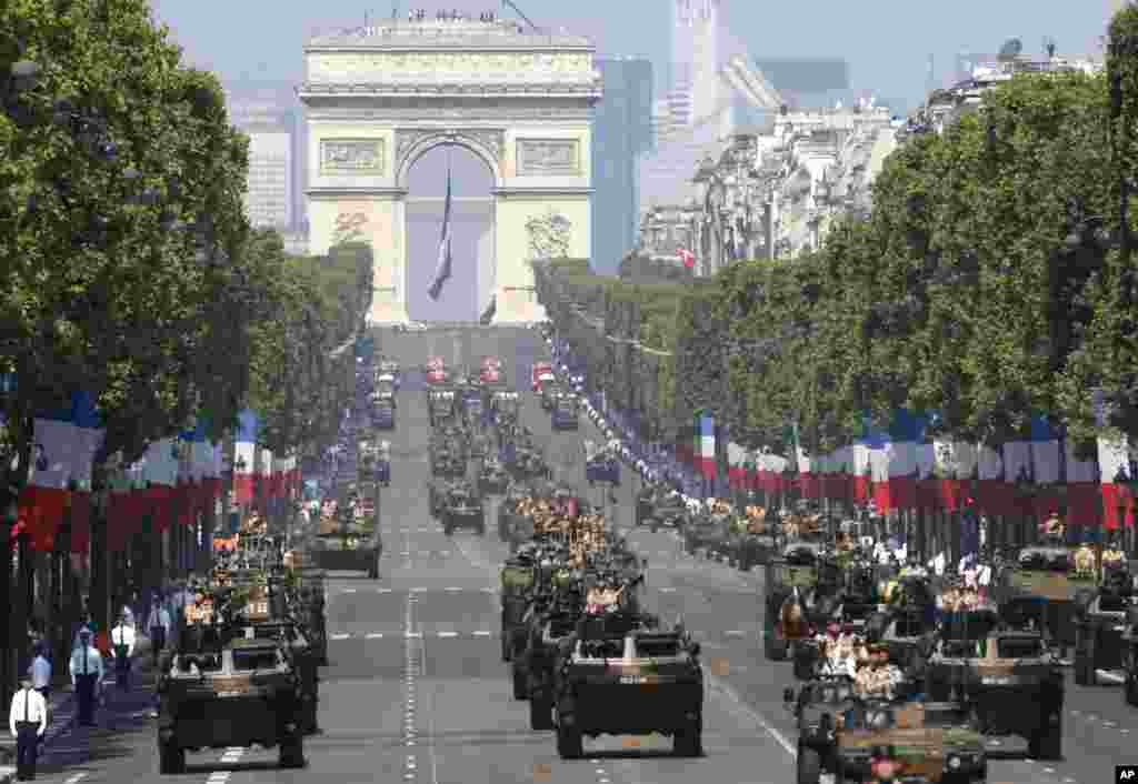 French soldiers stand in an armored vehicle during the Bastille Day parade in Paris, July 14, 2013.