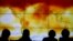 FILE - Participants are seen in silhouette as they look at a screen showing a world map with climate anomalies during the World Climate Change Conference 2015 (COP21) at Le Bourget, near Paris, France, Dec. 8, 2015. 