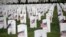 U.S. flags are seen at grave sites at Arlington National Cemetery in Arlington, Virginia, May 24, 2019, ahead of Memorial Day weekend.
