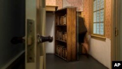 FILE- A woman enters the secret annex at the renovated Anne Frank House Museum in Amsterdam, Netherlands, Nov. 21, 2018.
