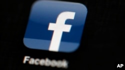 FILE - The Facebook logo is displayed on an iPad in a May 16, 2012 illustration photo. 