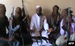 FILE - Boko Haram leader Abubakar Shekau, center, is flanked by militants. Nigeria's military said it had killed the second-in-command of Islamist group Boko Haram while repelling an insurgent attack earlier in April 2012.